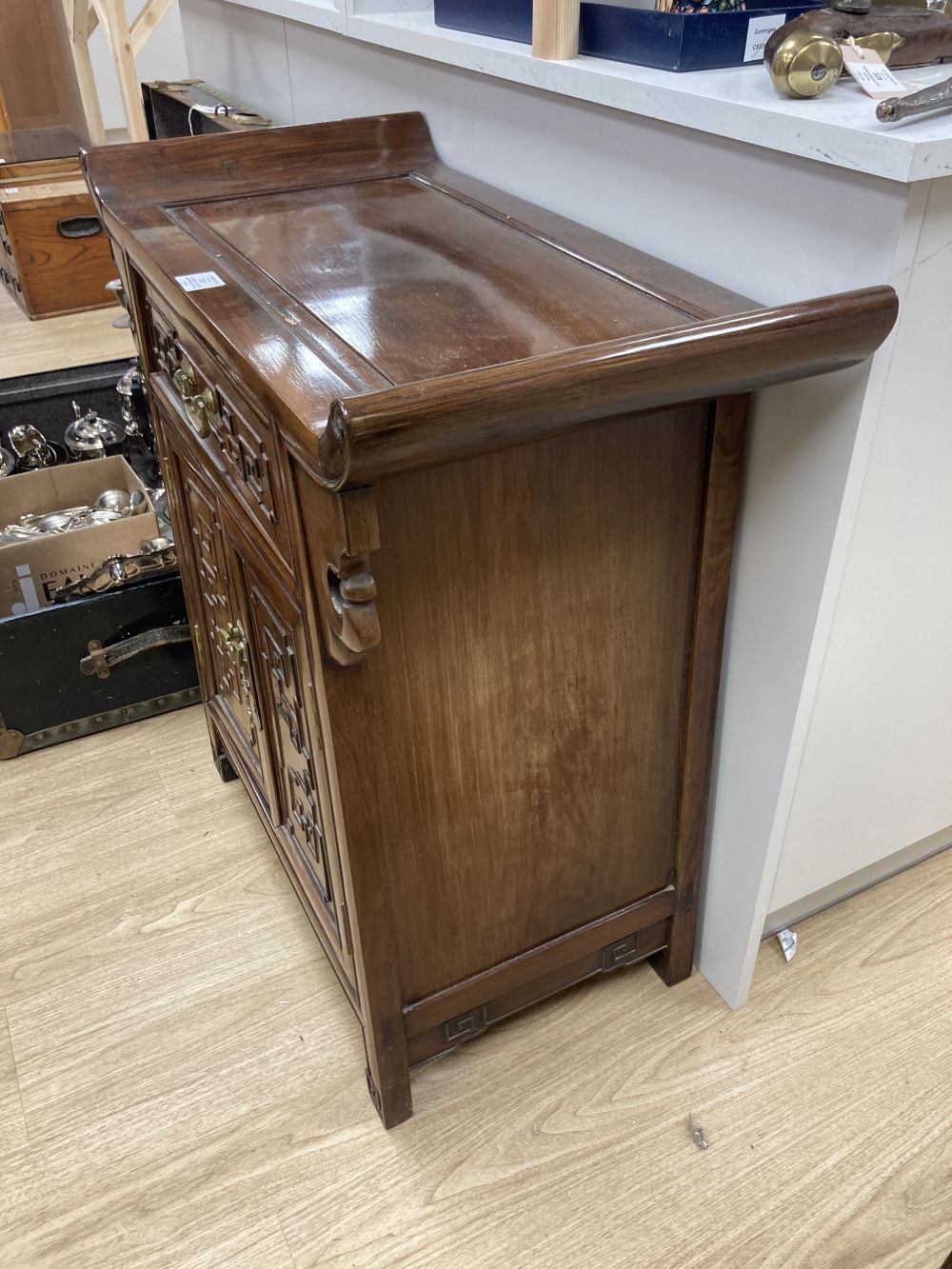 A Chinese carved hardwood side cabinet, fitted one long drawer over a pair of doors, width 70cm depth 38cm height 80cm
